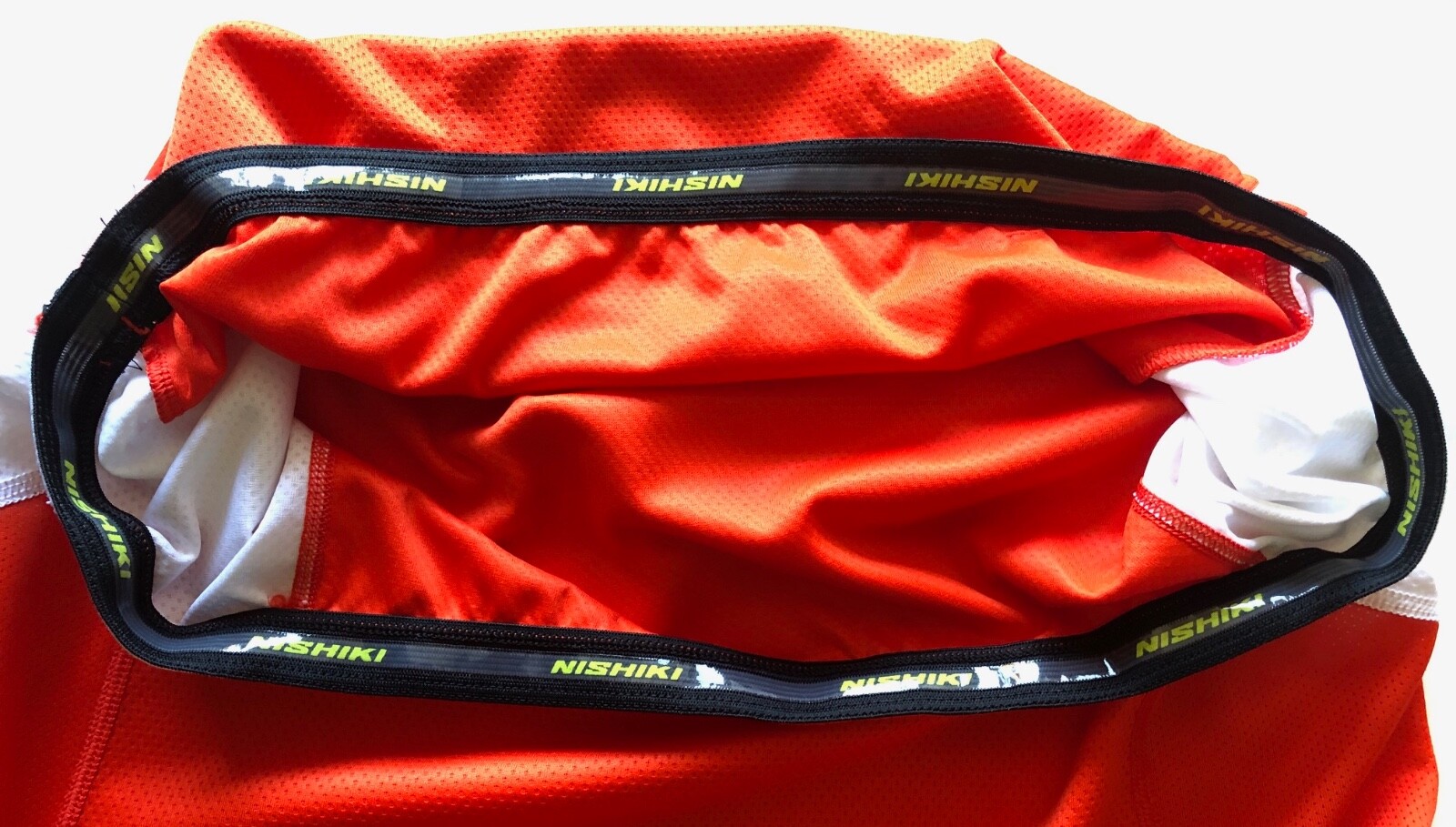 Nishiki mens orange & white cycling jersey elasticated waist 3 pockets US size M