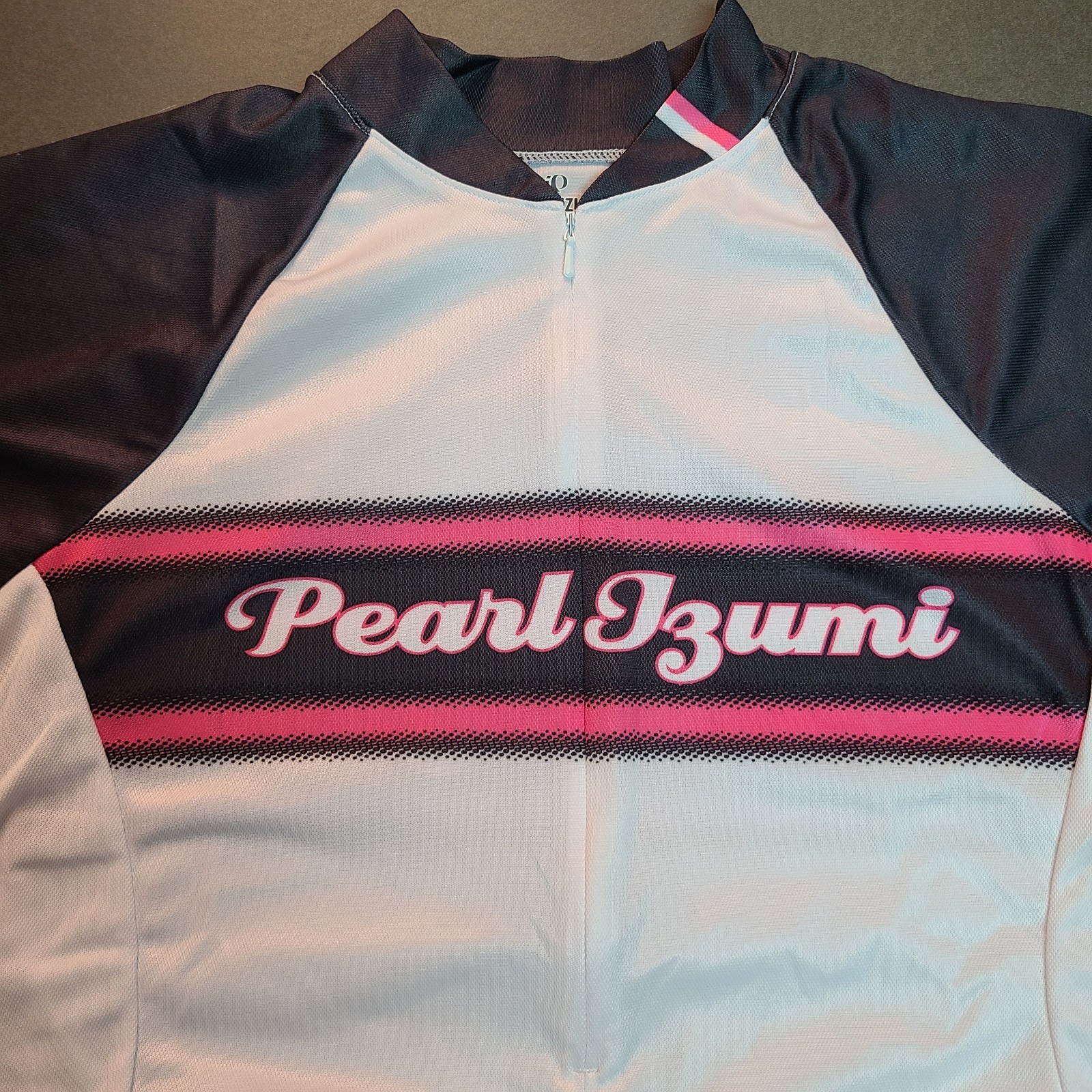 Women’s Pearl Izumi Cycling Jersey Size L White Spell Out SS Pockets 3/4 zip