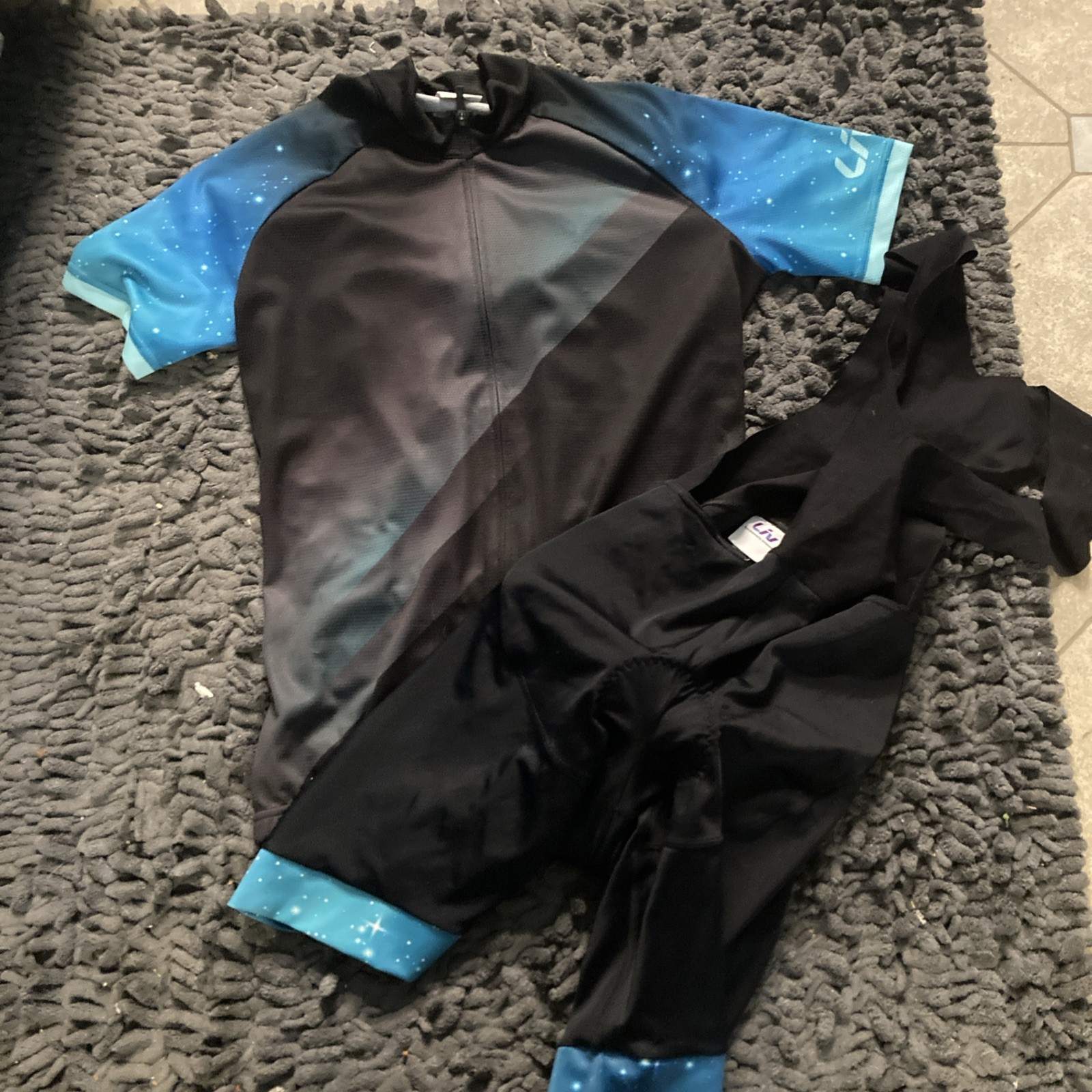 Liv Cycling Women’s Cycling Jersey Large, & Medium Bib Set, Black W/ Blue Galaxy