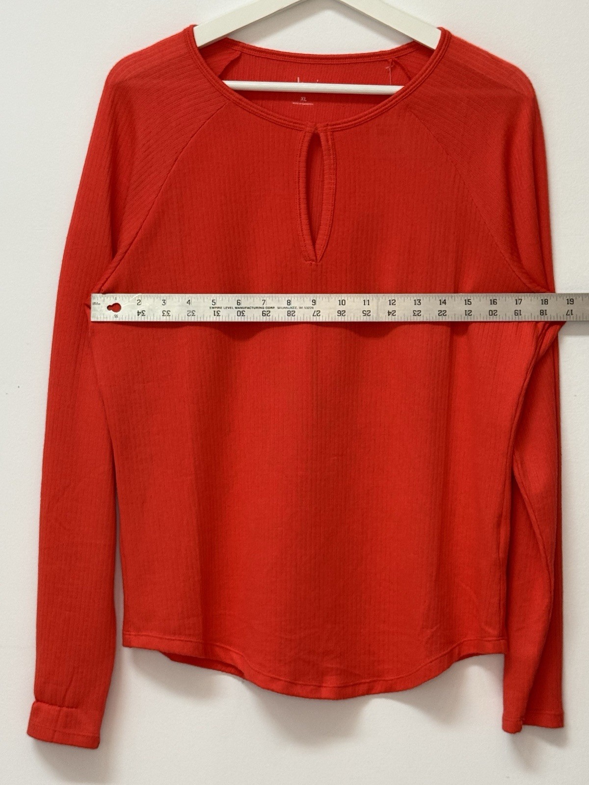 Red long sleeve top with keyhole neckline, soft ribbed fabric, casual chic.