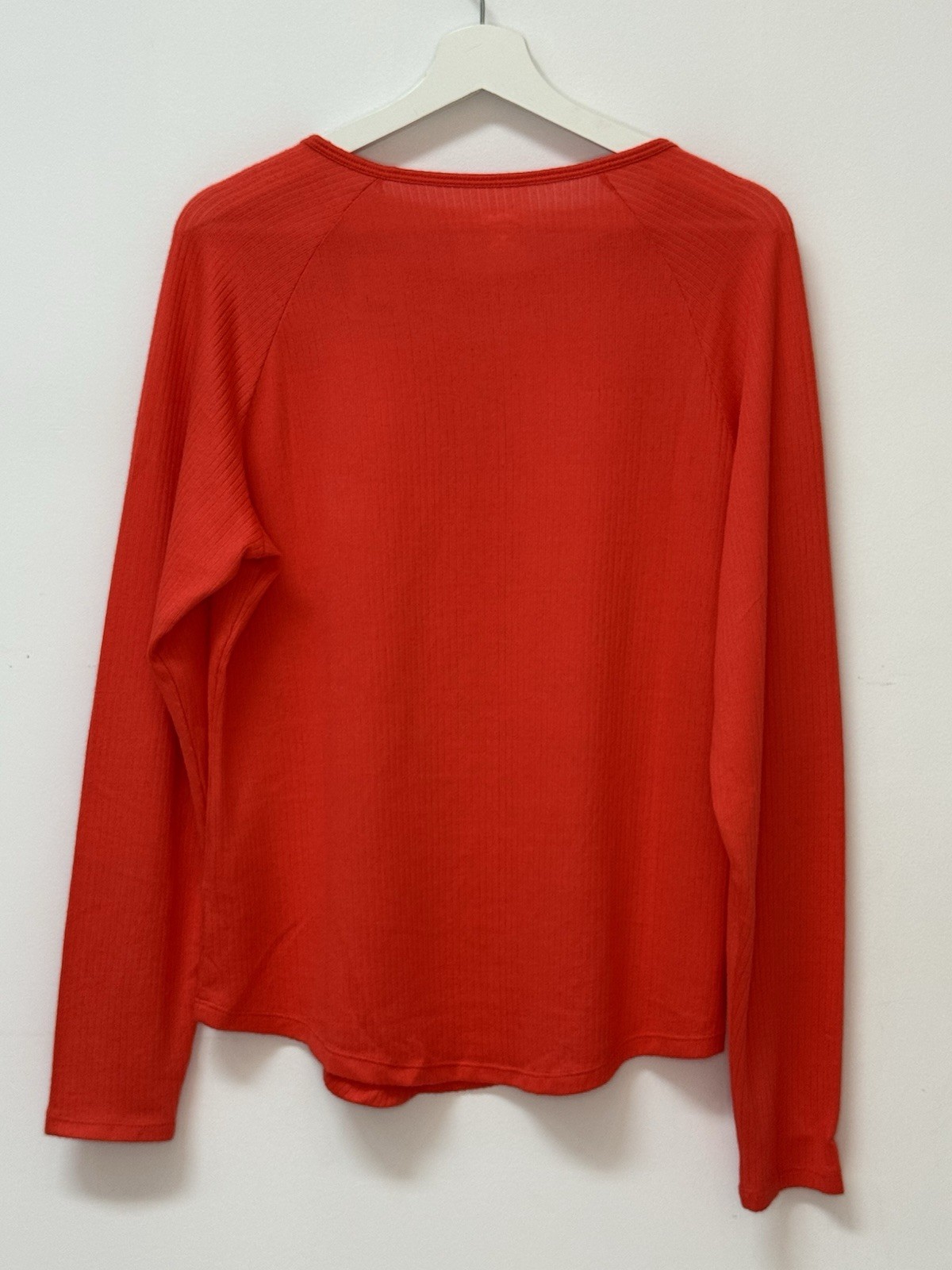 Red long sleeve top with keyhole neckline, soft ribbed fabric, casual chic.